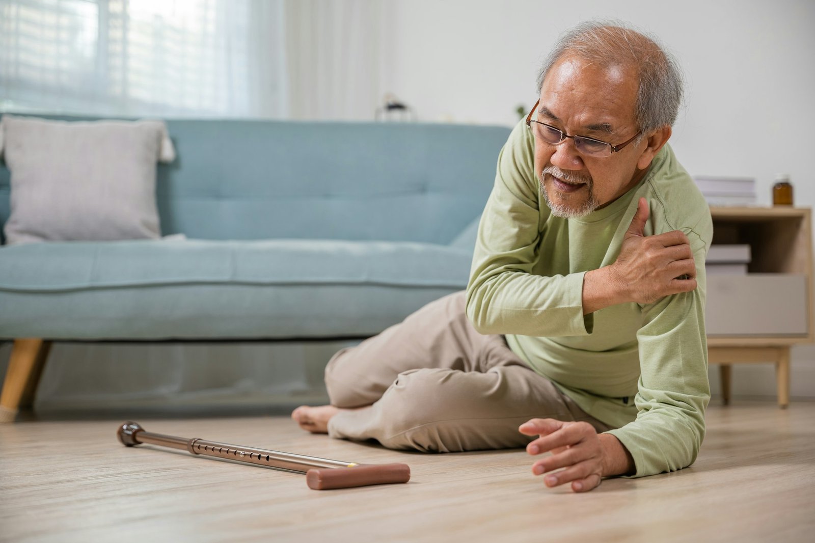 Older senior man headache lying on the floor after falling